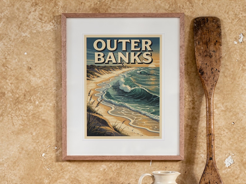 Outer Banks Surf Travel Poster print in a Red Oak frame with a white mat, hanging above the table in a boho living room.