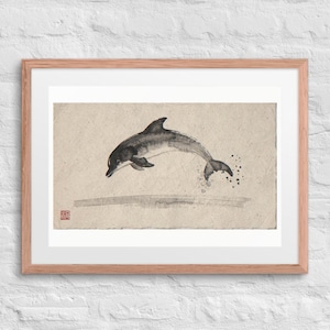 Leaping Dolphin Xieyi Ink print in a Red Oak 24 by 18 inch frame with a white mat on a white brick wall.