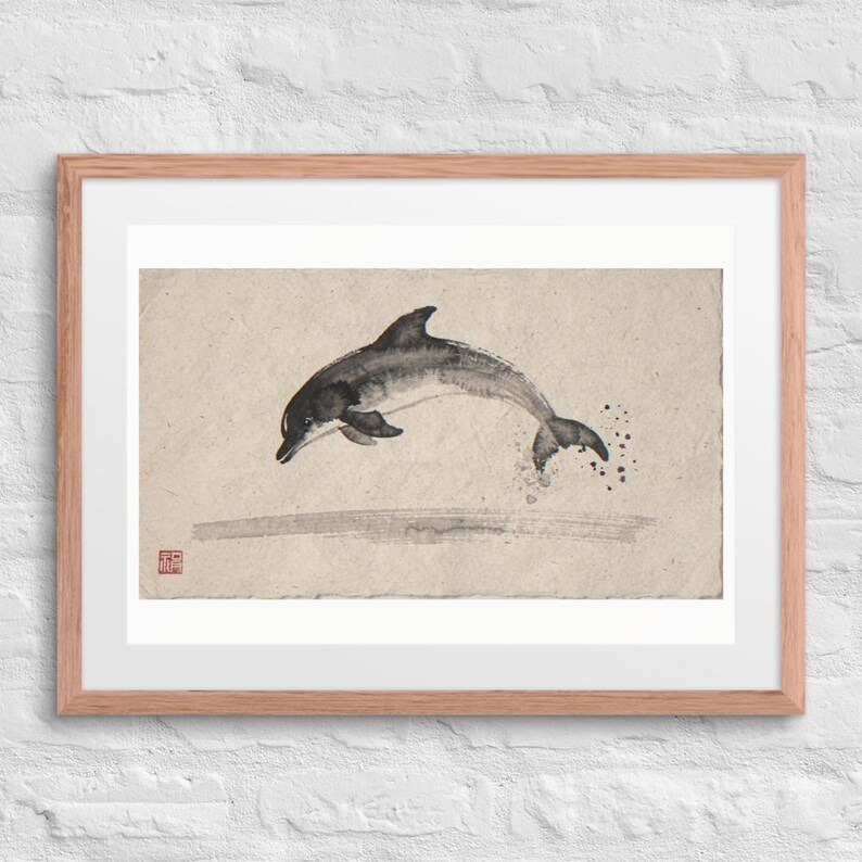 Leaping Dolphin Xieyi Ink print in a Red Oak 24 by 18 inch frame with a white mat on a white brick wall.