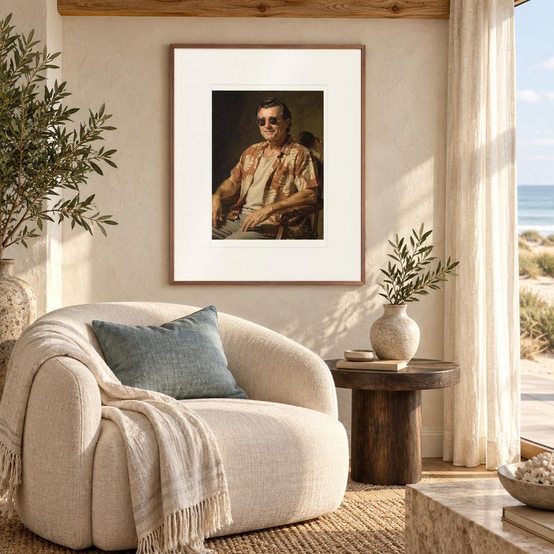 James Monroe Surfer print in a Red Oak frame with a white mat in a light-filled coastal sitting room.