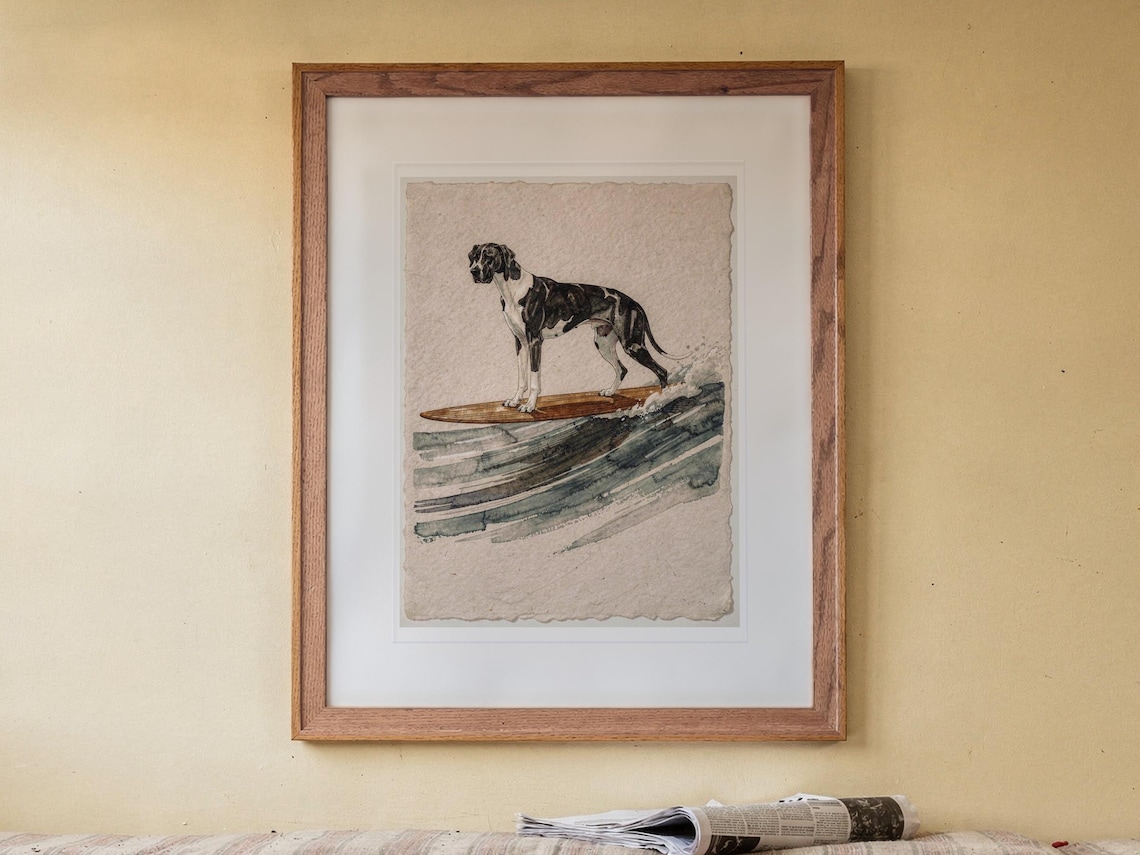 Great Dane Surfing print in a Red Oak frame with a white mat, hanging above the bench in a breakfast nook.