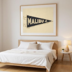 Malibu Vintage Surf Pennant Print framed in a modern bedroom setting