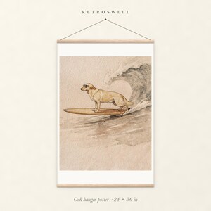 Yellow Labrador Surfing oak hanger poster, 24 by 36 inches, with natural wood rails and a hanging cord.