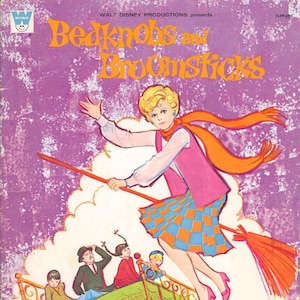 May include: A vintage book cover for "Bedknobs and Broomsticks" by Walt Disney Productions. The illustration features a woman flying on a broom, wearing a pink outfit and orange scarf. Below, a bed with children floats above a cityscape. The book is an authorized edition.
