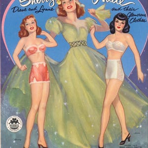 May include: Vintage paper doll illustration featuring three women: Sherry, Diane, and Adele. The artwork showcases glamorous clothes, including a green gown and lingerie. The background is a blue heart shape with stars, and the text reads "Sherry and Adele and their Glamorous Clothes."