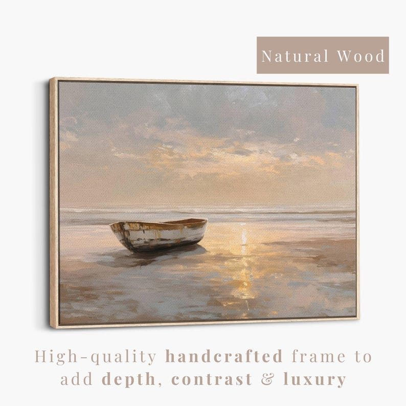 May include: A framed canvas art print depicts a serene beach scene with a small boat on the shore. The artwork features a natural wood frame and a muted color palette of beige, gray, and gold. The text "Natural Wood" is at the top.