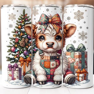 May include: A white tumbler featuring a cartoon calf wearing overalls and a bow, surrounded by a Christmas tree, presents, and snowflakes. The calf has brown and white fur and large eyes. The tumbler is approximately 8 inches tall.