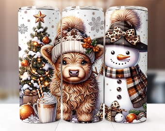 May include: Three white insulated tumblers with festive winter designs. One features a Christmas tree, another a Highland cow in a hat, and the third a snowman with a plaid scarf. Each tumbler has a lid and is decorated with snowflakes.