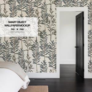 May include: A white wall with a leafy green and brown wallpaper pattern. The wallpaper has a repeating pattern of stylized leaves and branches. A white door frame with a black door is on the right side of the image. A white bed with a white blanket is on the left side of the image. The text "SMART OBJECT WALLPAPER MOCKUP" is in the upper left corner of the image. The text "PSD • PNG" is below the title. The text "@itsbreakinmockups" is below the PSD and PNG text.