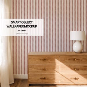 May include: A wooden dresser with six drawers and gold-colored hardware is positioned in front of a striped wallpaper. A white lamp with a rounded base sits on the dresser. The wallpaper has vertical stripes in white and a muted red color. Text on the image reads "SMART OBJECT WALLPAPER MOCKUP".