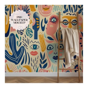 Puede incluir: Una maqueta de papel tapiz colorida con un patrón caprichoso de caras, ojos y formas abstractas en tonos de azul, rosa, amarillo y verde. Una escalera de madera se apoya en la pared, con una manta beige drapeada sobre ella.