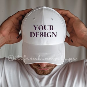 May include: White baseball cap with a curved brim and a purple text overlay that says "YOUR DESIGN".