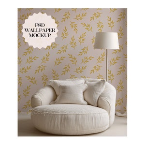May include: A white armchair with a round base sits in front of a wall with a light pink background and a repeating pattern of gold leaf branches. A white lamp with a gold base stands to the right of the chair. The text "PSD WALLPAPER MOCKUP" is in a white circle with a gold border.