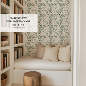 May include: A cozy reading nook with built-in white bookshelves and a bench. The wall is covered in a floral wallpaper with green leaves and pink accents. Beige pillows and a wooden stool complete the space. Text on the image reads "SMART OBJECT WALLPAPER MOCKUP".