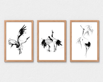 May include: Three framed black and white ink drawings of cranes. The first drawing shows a crane in flight. The second drawing shows two cranes standing together. The third drawing shows a crane standing in a bamboo forest.