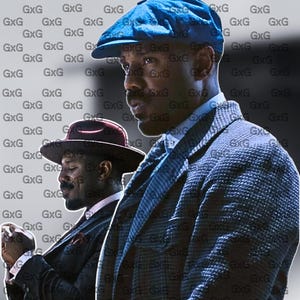 May include: Two men in suits and hats. One man wears a blue newsboy cap and a patterned blazer. The other man wears a brown fedora and a dark suit. The background has a repeating pattern of the letters "GxG".