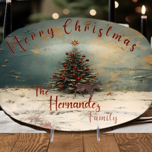 May include: Oval ceramic serving platter with a vintage Christmas scene. The platter features a blue and green background with a snowy landscape, a Christmas tree with red ornaments, and a deer. The text "Merry Christmas The Hernandez Family" is printed in red on the platter.