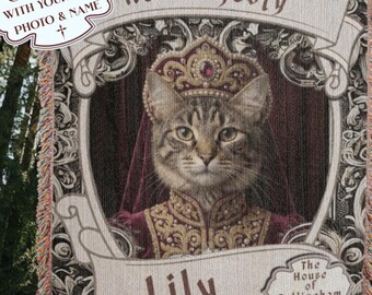 May include: Customizable woven tapestry featuring a regal cat portrait wearing a crown and royal attire. The tapestry includes the text "Her Majesty" and "Lily", with a decorative border and fringe.