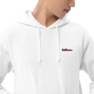 May include: White hooded sweatshirt with a small embroidered image of a red race car on the left chest.