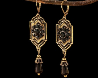 Very beautiful gold/bronze earrings in an antique boho style, rectangular, rounded, openwork, hanging black drops set with crystals