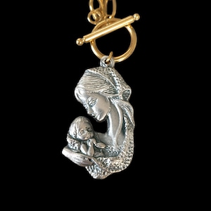 Superb modern gold-colored chain choker charm pendant necklace with its vintage Virgin Mary and child pendant.