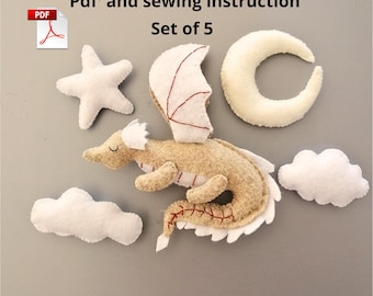 May include: A set of five felt ornaments, including a dragon, a star, a crescent moon, and two clouds. The dragon is beige with red stitching and white wings. The ornaments are for sewing and come with a PDF instruction guide. Set of 5.