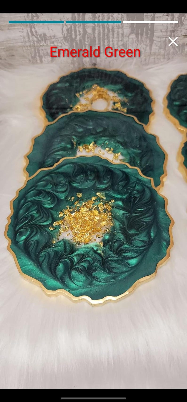 May include: Emerald green resin coasters with gold leaf accents and gold trim. The coasters have a unique, organic shape and are arranged on a white, fluffy surface. The text "Emerald Green" is visible at the top.