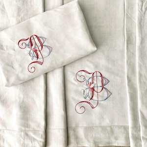 Antique linen Single Bedding Set with embroidered monogrammed cover sheet and Pillow Sham in pink, red and blue. Antique bedding