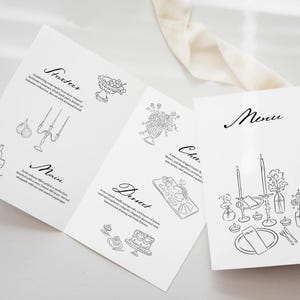 May include: A black and white wedding menu with the words "Menu", "Starters", "Main", "Dessert", and "Cheese" written in cursive. The menu includes a list of food items and illustrations of a bowl of fruit, a bouquet of flowers, a cheese board, a cake, and a table setting with candles and flowers.