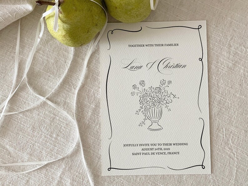 May include: A white wedding invitation with black calligraphy announcing the wedding of Lama and Christian. The invitation includes the date, August 24th, 2025, and the location, Saint Paul de Vence, France.