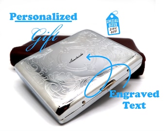 May include: A silver metal case with an engraved floral design and the word "Anastaiska" engraved on the top. The words "Personalized Gift" and "Engraved Text" are written in blue. A tag indicates a 20% discount.