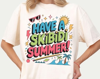 May include: A white t-shirt with a colorful graphic design that says "Have a Skibidi Summer!" The design includes a sun, palm trees, waves, a pencil, a book, an apple, and sunglasses.
