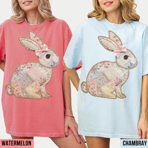 May include: Two oversized t-shirts with a patchwork bunny design. The shirt on the left is watermelon pink and the shirt on the right is light blue.
