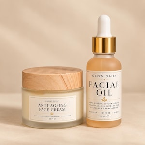 May include: A 50 ml glass jar of anti-ageing face cream with a light wood grain lid and a 30 ml glass dropper bottle of facial oil with a gold collar and white dropper top. Both containers feature white labels with black text and gold accents.