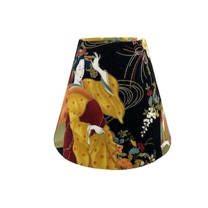 May include: A black lampshade with a conical shape features a colourful Japanese-inspired print of a woman in a yellow and red kimono with floral accents. The background is black with gold and white swirling patterns.