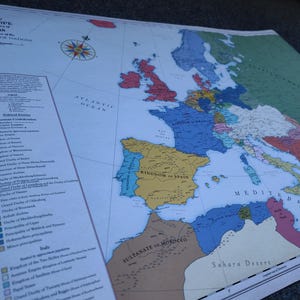May include: A vintage map of Europe in 1848, showing the political boundaries of the different nations. The map is printed on a white background with blue, yellow, red, green, and brown colors. The map includes the Atlantic Ocean, the Mediterranean Sea, and the Sahara Desert.