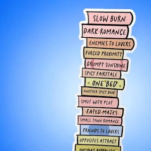 May include: A sticker depicting a stack of books with titles such as "Slow Burn" and "Dark Romance." The books are in pastel shades, held against a blue backdrop.