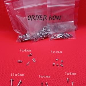 May include: Four bags of silver metal letter and number charms in various sizes. The bags are labeled with the size of the charms in millimeters. The bags are on a red surface. The text "ORDER NOW" is printed on the bags.
