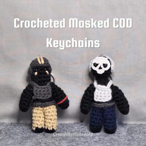 May include: Two crocheted keychains of masked figures. One figure has a black mask, gray vest, tan pants, and a red stripe on the arm. The other figure has a skull mask, white vest, and blue pants. The text "Crocheted Masked COD Keychains" is at the top.