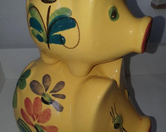 Two cute german piggy banks in bright yellow