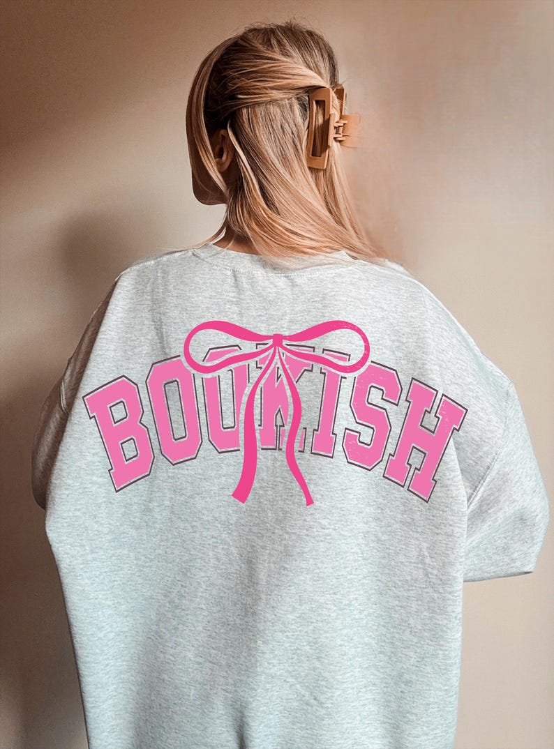May include: Gray sweatshirt with a pink bow and the word "BOOKISH" printed in pink and black on the back.