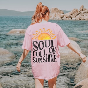 May include: A pink t-shirt with a graphic of a sun and the text "Soul Full of Sunshine".