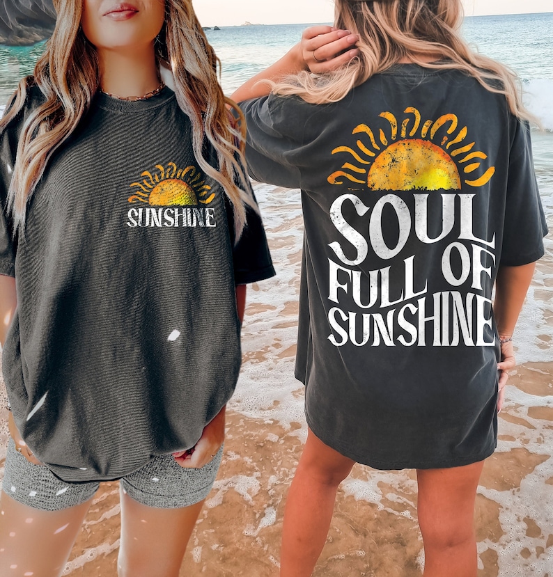 May include: Two people wearing gray t-shirts with a vintage sun graphic and the text "Sunshine" and "Soul Full of Sunshine".