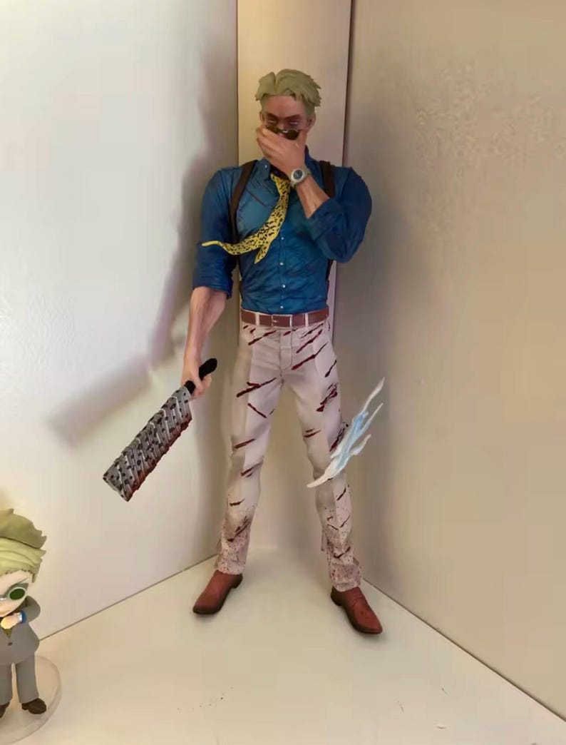 May include: A detailed figurine of a character in a blue shirt, tan pants with red markings, and brown shoes. The figure is holding a large, serrated weapon in one hand and a blue, stylized energy effect in the other. A yellow and black patterned tie is visible.