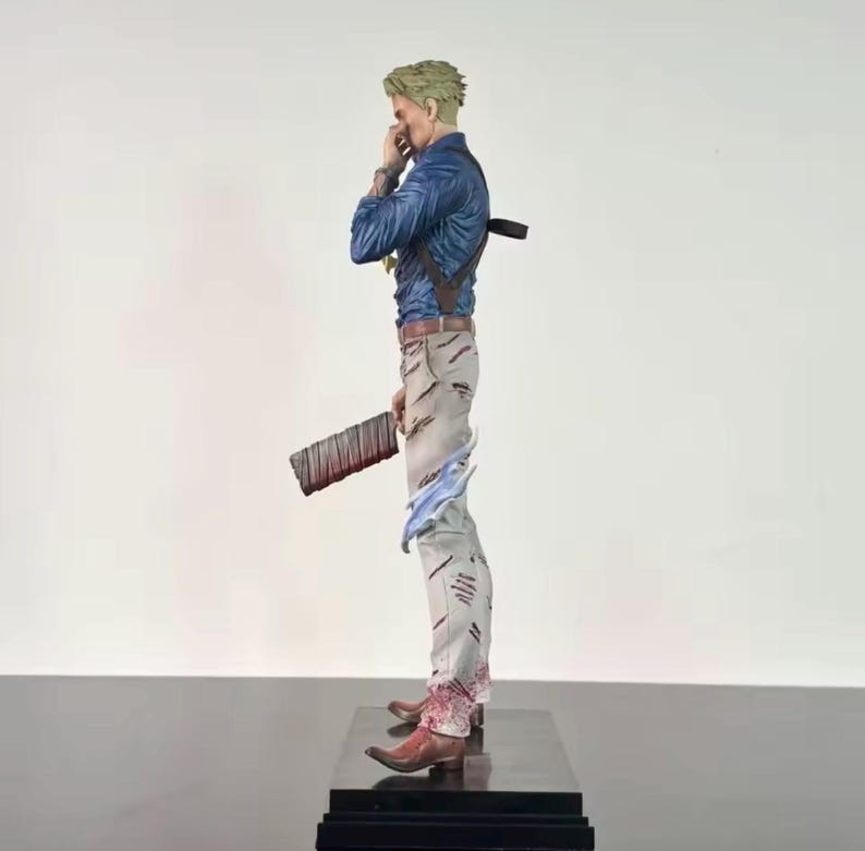 May include: A detailed figurine of a character in a blue shirt, light gray pants, and brown boots. The figure is holding a large, dark brown object with red accents. The figure is standing on a black base.