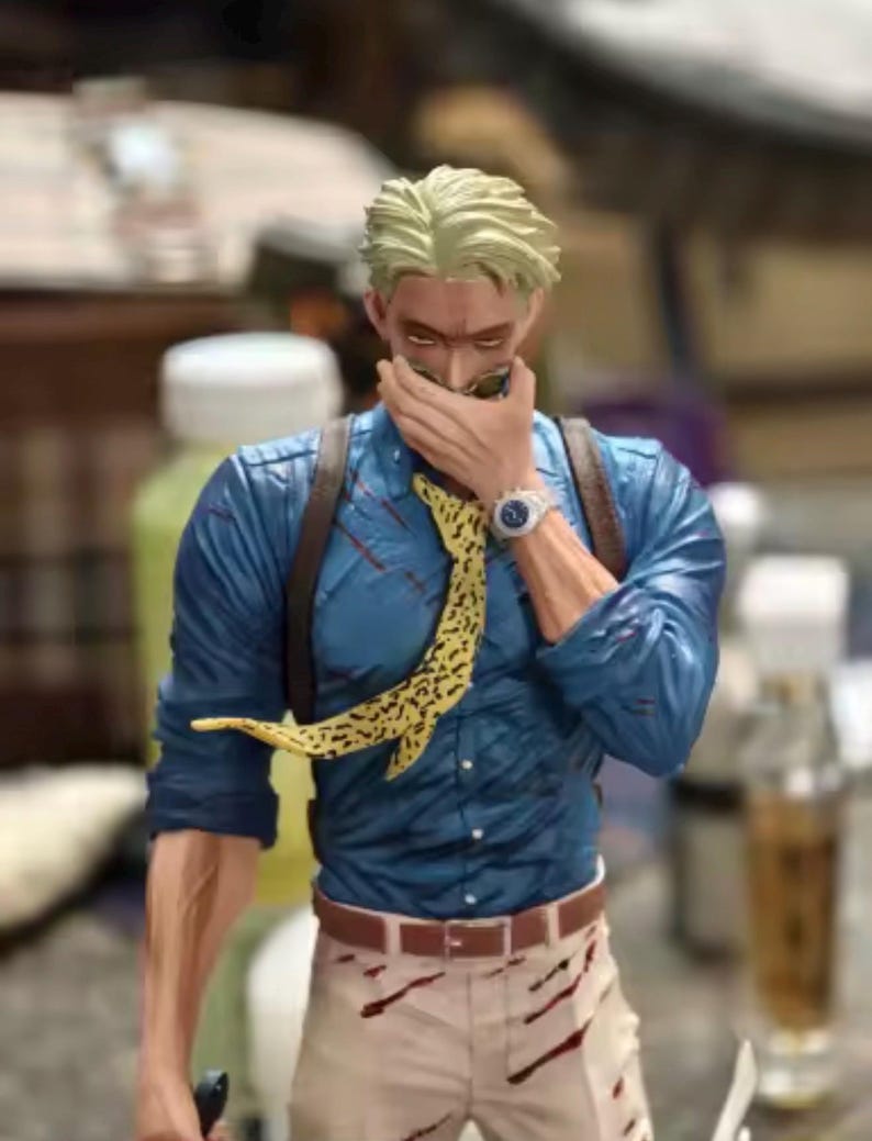 May include: A figurine of a character with blond hair, wearing a blue shirt, tan pants, and a yellow patterned tie. The figure has a watch and sunglasses. The figure is holding a hand up to its face.