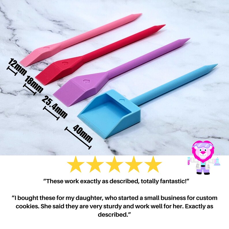 May include: Four plastic tools for decorating cookies. The tools are pink, red, purple, and blue. The tools are different sizes, with the smallest being 1.2 inches long and the largest being 1.6 inches long. The tools are on a white marble surface.