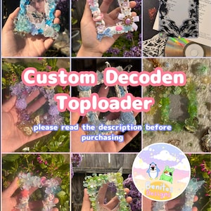 May include: A collection of custom Decoden toploaders in various colors and designs. The toploaders are decorated with resin, bows, flowers, and other embellishments. The text "Custom Decoden Toploader" is visible, along with a request to read the description before purchasing.