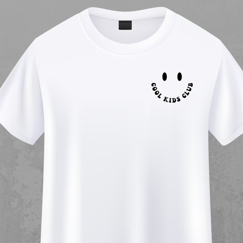 May include: White t-shirt with a black graphic of a smiley face and the text "COOL KIDS CLUB" around the face.