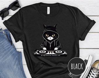 May include: Black t-shirt with a graphic of a black cat wearing a hoodie and holding a DJ mixer. The text "progressive house cat" is printed below the cat.